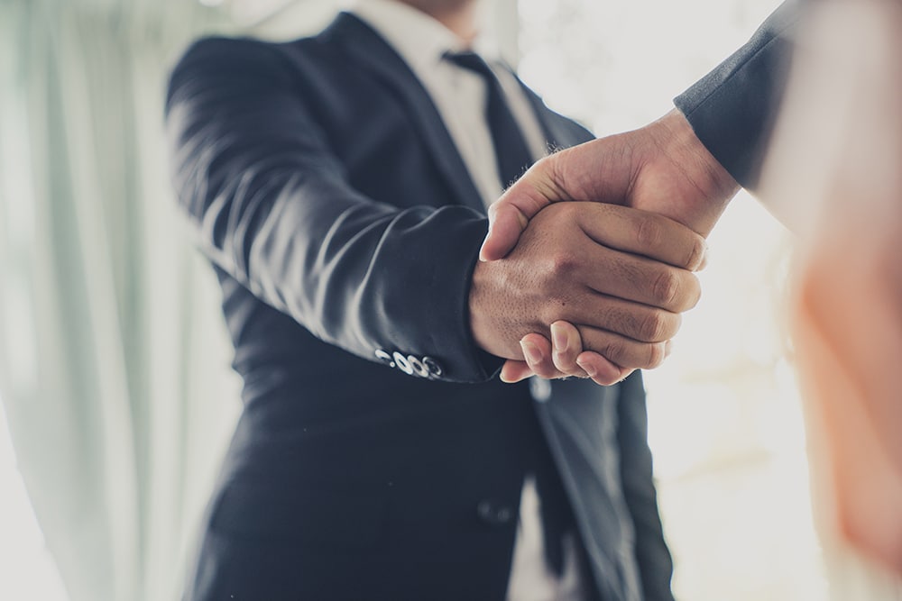Businessman shake hands agree deal of big lot sales that finish